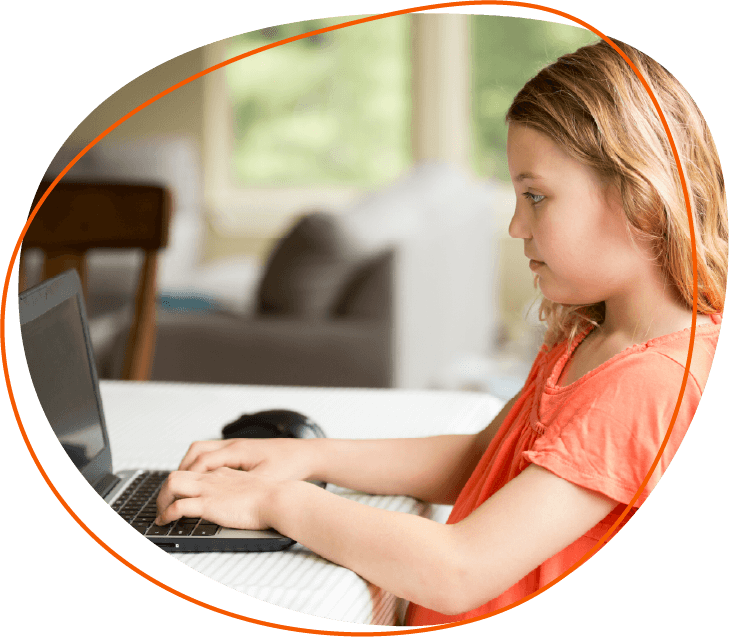 girl on small laptop with window in the background