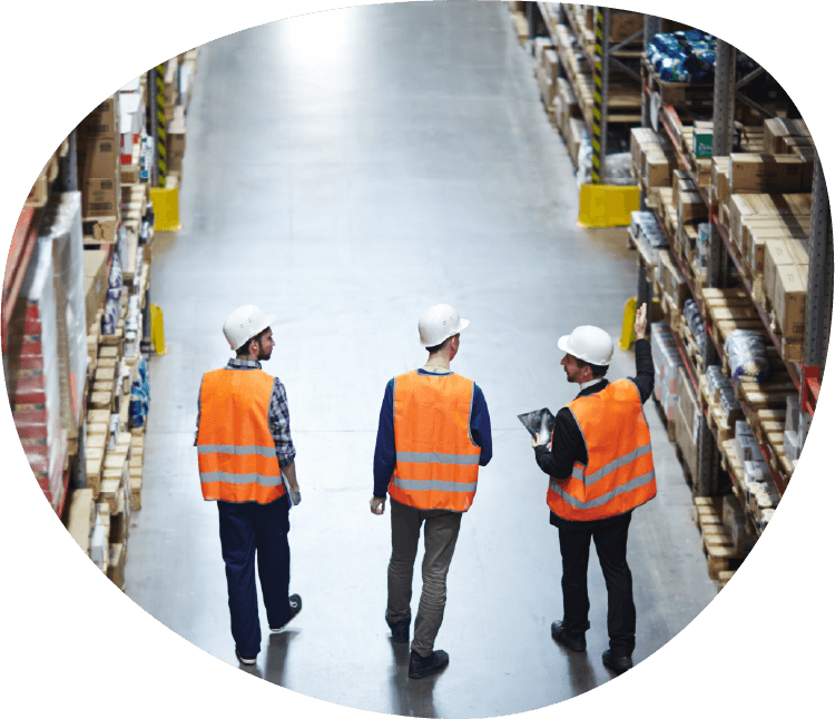 3 men in orange hazard jackets and boxed around