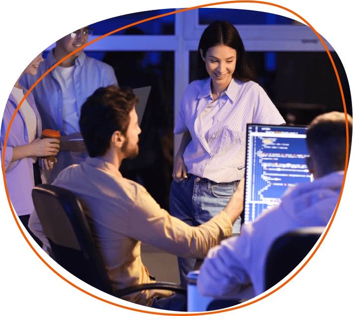 people crowding around a desktop computer